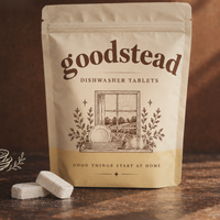 Goodstead dishwasher tablet pouch and tablets on a wooden counter
